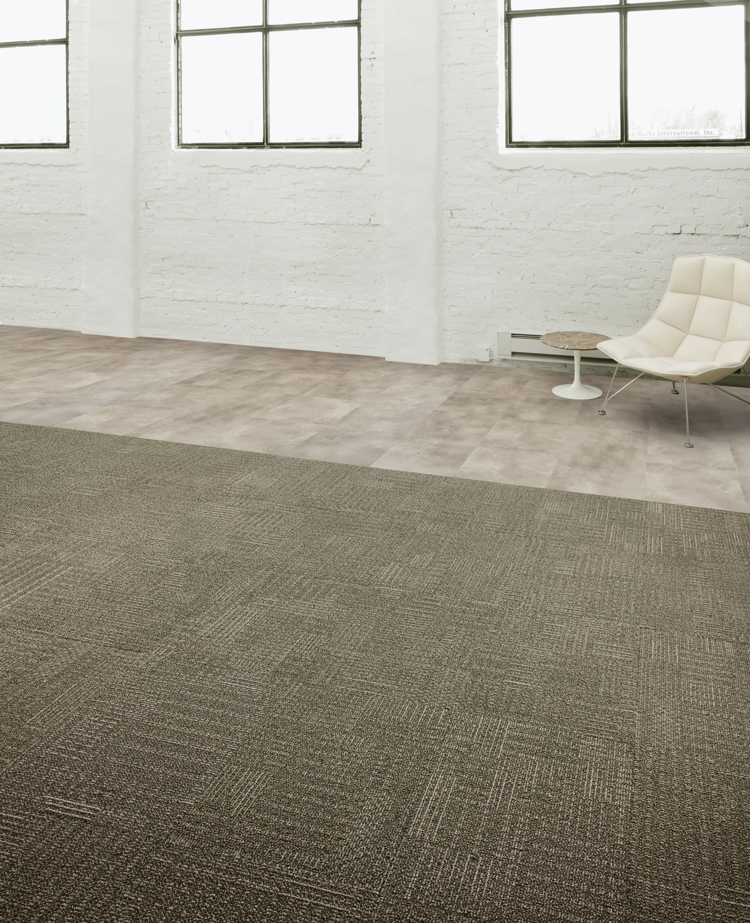 Interface CT101 carpet tile and Textured Stones LVT in open area with concrete walls and chair image number 5